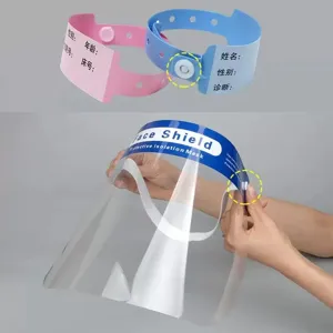 Disposable plastic face shield and patient wristband set with snap button closure for safety.