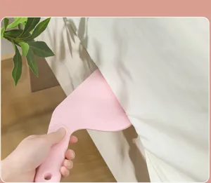 Handheld plastic bed sheet tucking tool and mattress lifter for effortless bed making.