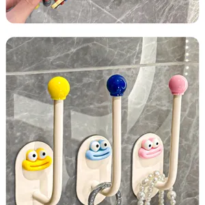 Cute cartoon monster wall hook punch-free storage rack for bathroom accessories and hair ropes.
