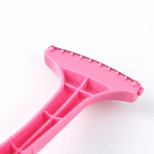 Pink plastic foot shaver callus remover for home pedicures with safe hidden blade design.