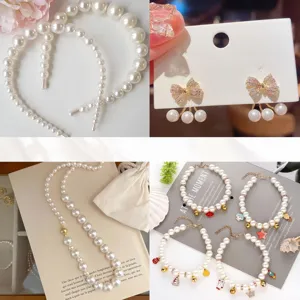 Detail view of various imitation pearl jewelry including headbands, earrings, and charm bracelets.