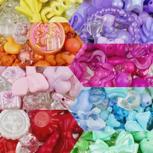 Close-up detail of colorful mixed acrylic beads in various cute shapes, ideal for DIY crafting.