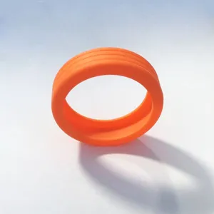 Orange silicone luggage wheel cover detail showing anti-slip texture and durable elastic material.
