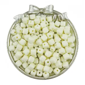 Close-up detail of 7x7mm acrylic square cube loose beads in pale yellow color with center hole for DIY.