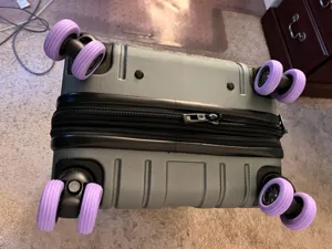 Silicone luggage wheel covers in purple, universal mute anti-wear caster protectors for travel suitcases.