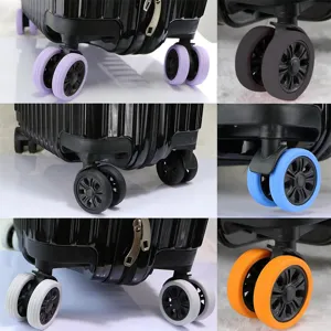 Close-up detail of silicone luggage wheel protective covers, shock-absorbing mute caster wraps.