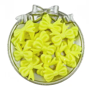 Yellow acrylic bow beads detail shot, ideal for DIY handmade charm bracelets and jewelry making.