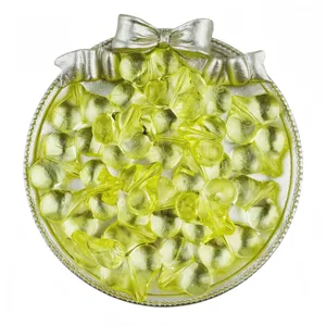 Detail view of transparent yellow peach heart acrylic loose beads in a silver bow tray.