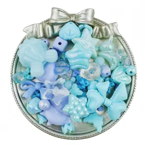 Detailed view of mixed blue acrylic beads, star and bow shapes for DIY jewelry crafts.