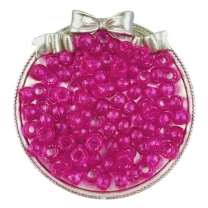 Close-up of pink glitter pony beads, 6x9mm large hole barrel beads for DIY craft projects.