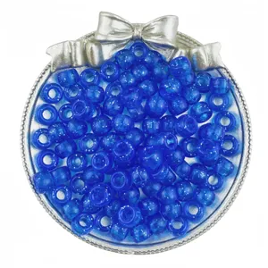 Blue glitter pony beads 6x9mm inside silver bow container for DIY hair braiding.