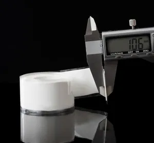 Detail view of white waterproof plumbing tape shown with a digital caliper measuring thickness.