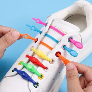 Detailed view of colorful silicone lazy shoelaces installed on white sneakers, high elasticity.