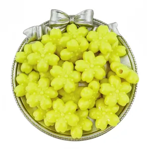 Close-up of yellow acrylic cherry blossom beads, perfect for DIY jewelry and hair accessories.