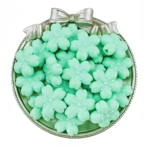 Close-up detail of light green acrylic cherry blossom beads, perfect for DIY jewelry and crafts.