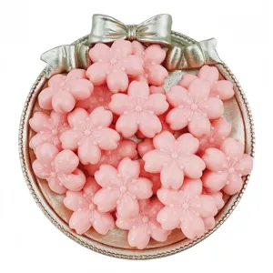 Detailed view of pink acrylic cherry blossom flower beads arranged neatly in a silver tray.