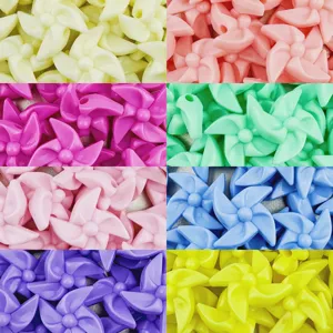 Closeup of 20mm acrylic pinwheel beads, colorful dopamine craft charms for DIY jewelry making.