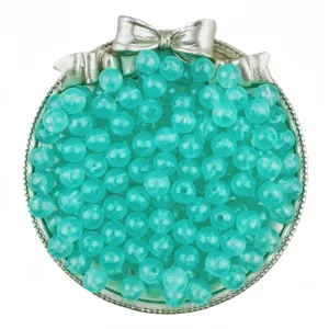 Detail shot of turquoise acrylic luminous jelly round beads in silver bow container for DIY craft.