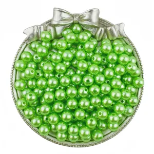 Close up detail of shiny green imitation pearl round beads with center hole for DIY jewelry crafts.