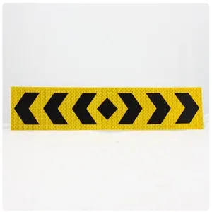Detail shot of the reflective safety tape with black chevron arrows on yellow background.