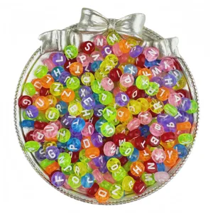 Close-up of colorful acrylic letter beads in a silver bow container for DIY jewelry making.