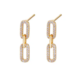 Detail shot of gold-plated geometric chain stud earrings with sparkling zirconia stones.