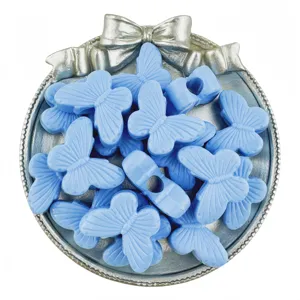 Close-up detail of light blue acrylic butterfly large hole beads for DIY jewelry making.
