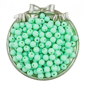 Mint green matte round beads with holes for DIY handmade jewelry, bracelets, and necklaces.