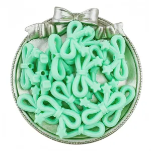 Close-up of mint green acrylic star bow beads, ideal for DIY handmade bracelet jewelry making.
