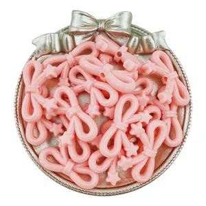 Detail shot of pink acrylic star bow beads, perfect for handmade DIY jewelry crafting.