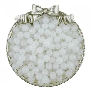 Closeup of translucent white acrylic jelly round beads with straight holes for DIY handmade jewelry.