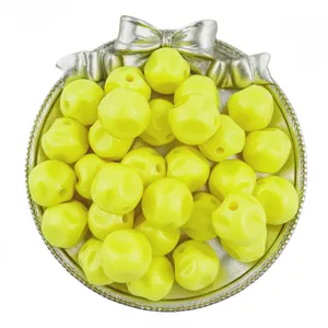 Close-up view of yellow acrylic beads in silver tray, perfect for handmade jewelry crafting details.