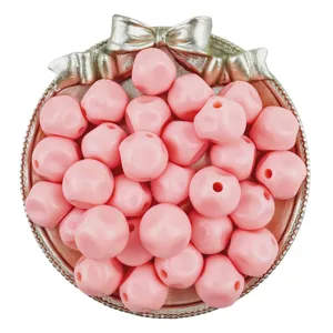 Detail view of 16mm pink solid acrylic loose beads in decorative tray for DIY handmade jewelry.