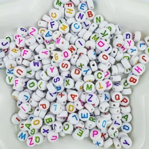 Detailed view of white acrylic alphabet letter beads with colorful letters for DIY jewelry.