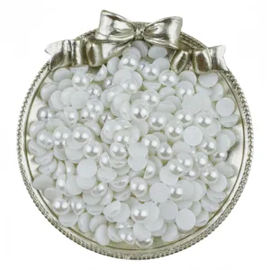 Détail de perles plates, demi-perles blanches d'imitation pour accessoires de bricolage DIY.