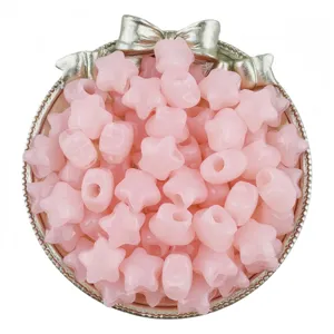 Close-up of pink jelly acrylic star beads in decorative bow tray for DIY jewelry making.