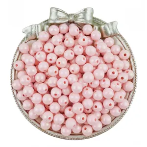 Close up detail of pink acrylic round beads with AB coating for handmade DIY jewelry bracelets.