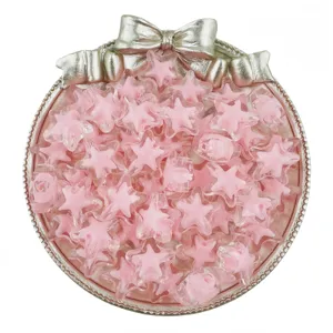Detailed view of 15mm pink acrylic star beads in a decorative bow tray for DIY jewelry making.