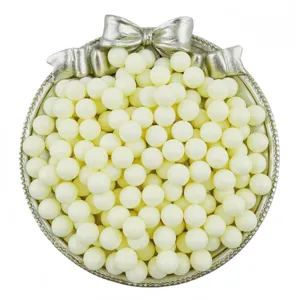 Close-up detail of white solid acrylic round beads without holes in a decorative tray.