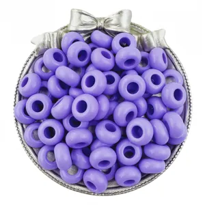 Detailed close-up of vibrant purple acrylic wheel beads showcased inside a silver dish.