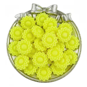 Detail view of yellow acrylic sunflower beads in a silver tray, perfect for DIY jewelry making.