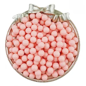 Close-up detail of pink solid round craft beads displayed in a decorative silver bow tray.