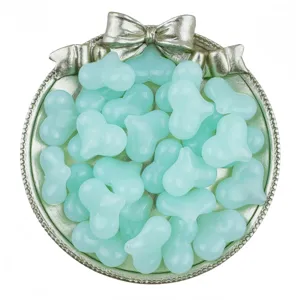 Close-up detail of 22mm mint green acrylic heart beads for handmade DIY jewelry crafting.