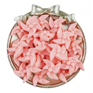 Pink acrylic pinwheel beads close up view, perfect for DIY handmade crafts and jewelry accessories.