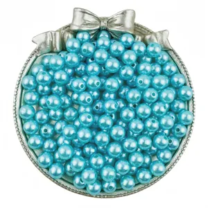 Detailed view of light blue ABS imitation pearls in a decorative silver tray for DIY jewelry.