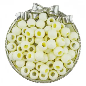 Detail view of creamy white acrylic large hole round beads for DIY bracelet crafting.