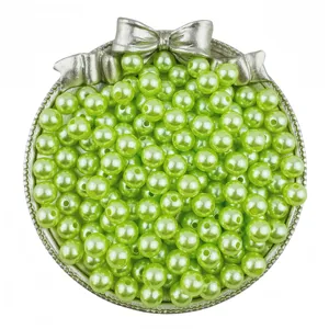 Green ABS imitation pearl beads with holes in bow tray, perfect for DIY jewelry crafting.
