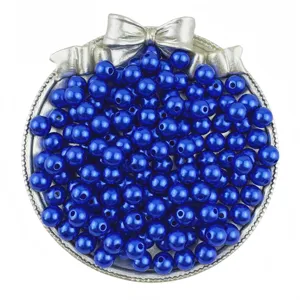 Close-up detail of shiny royal blue ABS imitation pearl beads displayed in a silver tray for DIY.