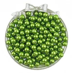 Close-up detail of green ABS imitation pearl beads with holes, perfect for DIY jewelry craft.