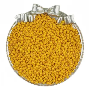 Yellow glass seed beads in a silver bow tray for DIY handmade jewelry bracelets necklaces